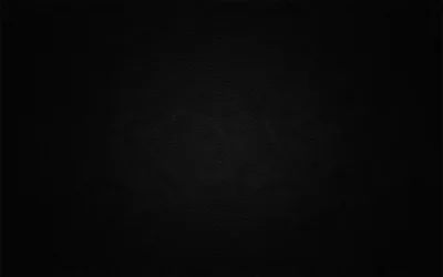 A soft round glow sits behind the middle of an otherwise black frame, faint enough that icons or text would sit over it cleanly.