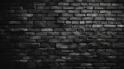 Weathered black brickwork fills the frame with the light concentrated in the centre, all four corners fading into black.