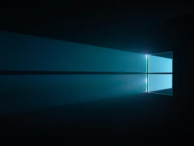 The Windows 10 hero window throws a wide teal beam across a dark reflective floor, the source sitting to the right of centre.