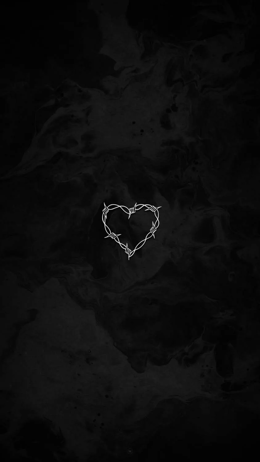 A thin scratched heart shape shows up faintly on a mottled charcoal surface, the upper third left almost entirely empty.