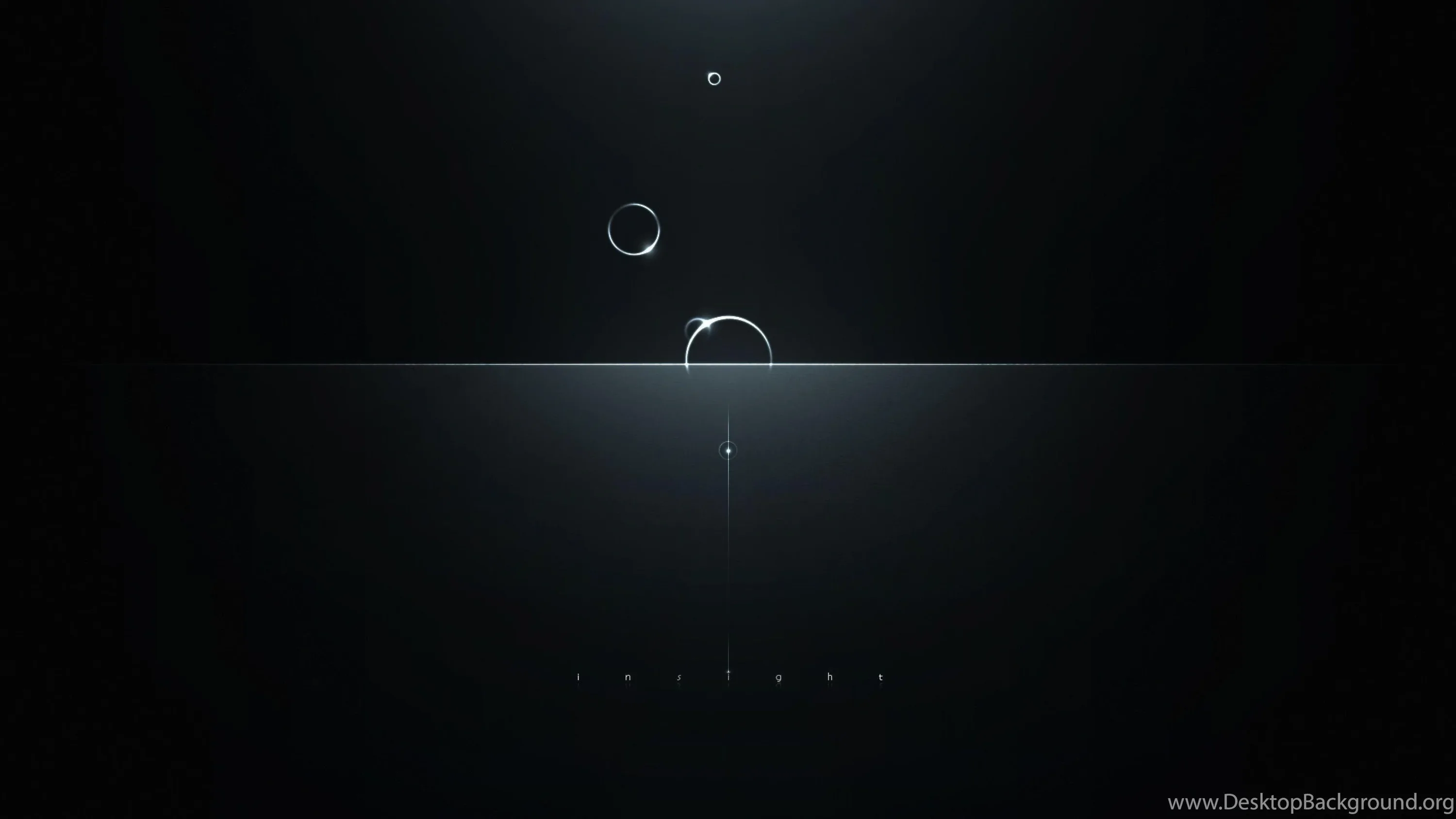 Three glass-like orbs of different sizes hover over a thin band of light that splits an otherwise black frame in two.