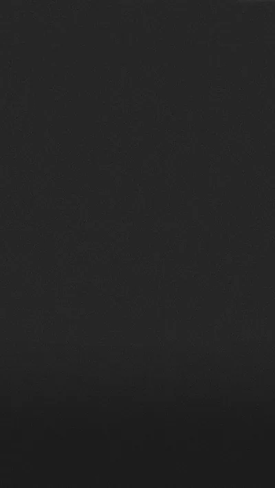 One flat matte charcoal tone with the faintest lift toward the top, nothing in it to compete with app icons or a lock screen clock.