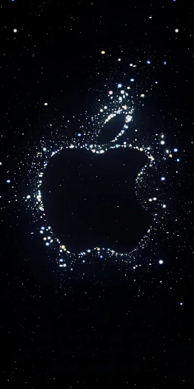 The Apple outline drawn from scattered white and blue sparks against deep space black, brightest along the leaf and the left edge.