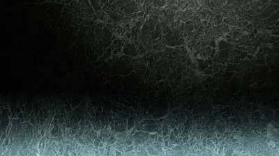 Fine crystalline threads spread across two bands of cold teal, split by a dark horizontal seam through the middle.