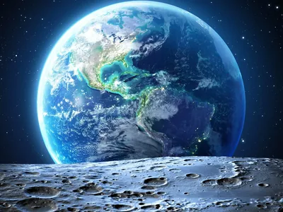 A large blue-toned Earth showing the Americas rises behind the Moon's cratered grey foreground, both lit crisply against a dark star field.