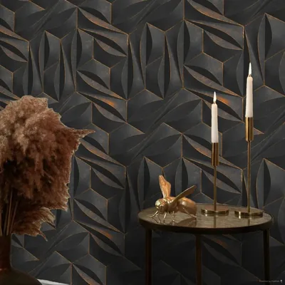 Faceted black wall panels traced with thin copper lines, styled with brass candlesticks and dried pampas grass along the bottom of the frame.