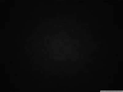 Woven canvas grain covers a black backdrop, lit softly from the left of centre so the corners drop into a heavy vignette.