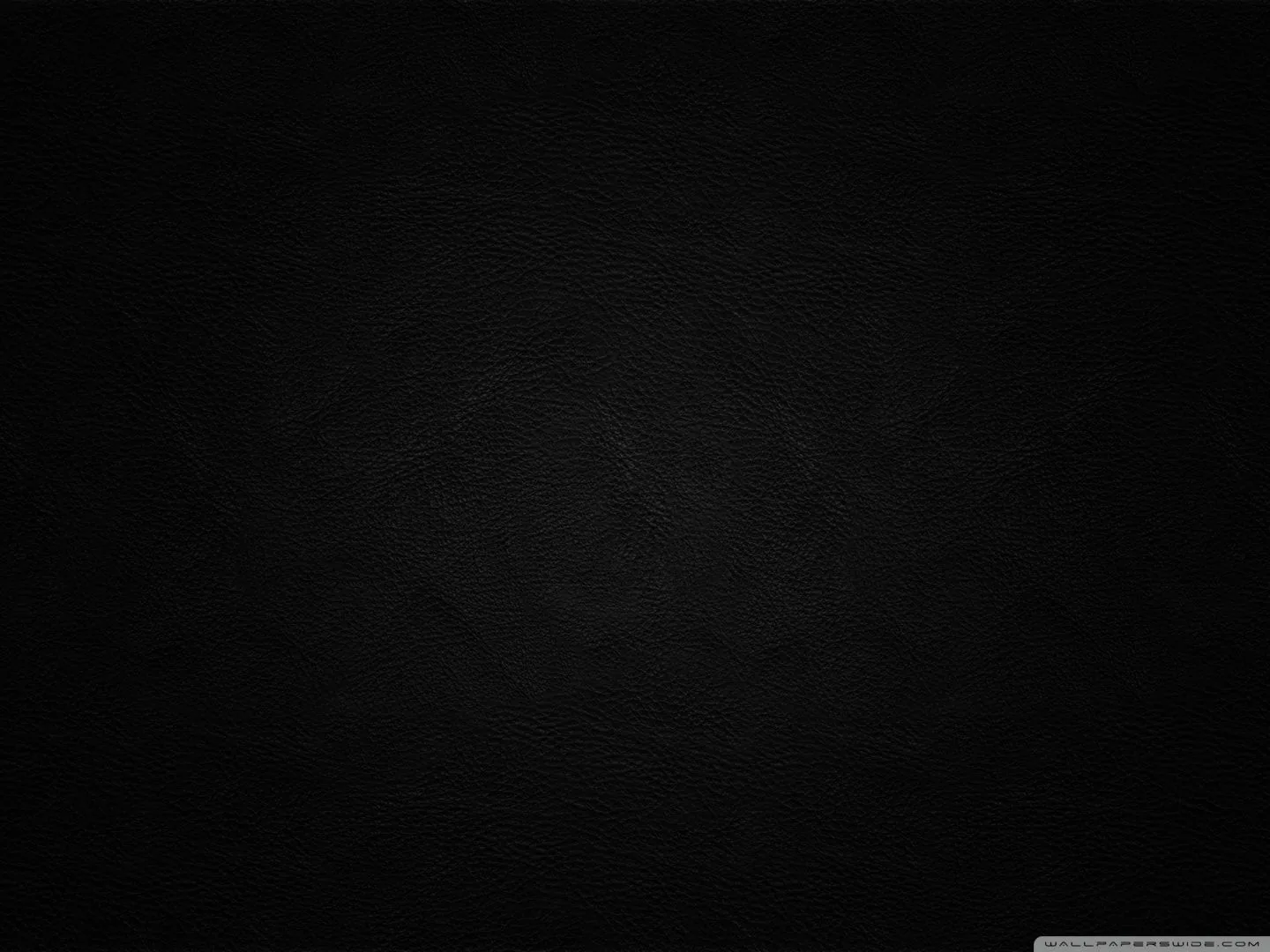 Woven canvas grain covers a black backdrop, lit softly from the left of centre so the corners drop into a heavy vignette.