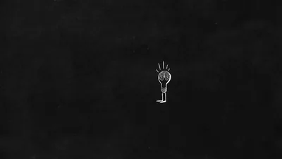 One small hand-drawn bulb with radiating dashes sits alone slightly right of centre, the rest a grainy near-black chalkboard texture.