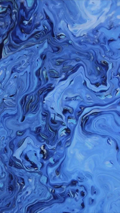 Cornflower blue paint folds over itself in slow marbled currents, brightest through the middle band, with thin navy veins tracing every curl of the pour.