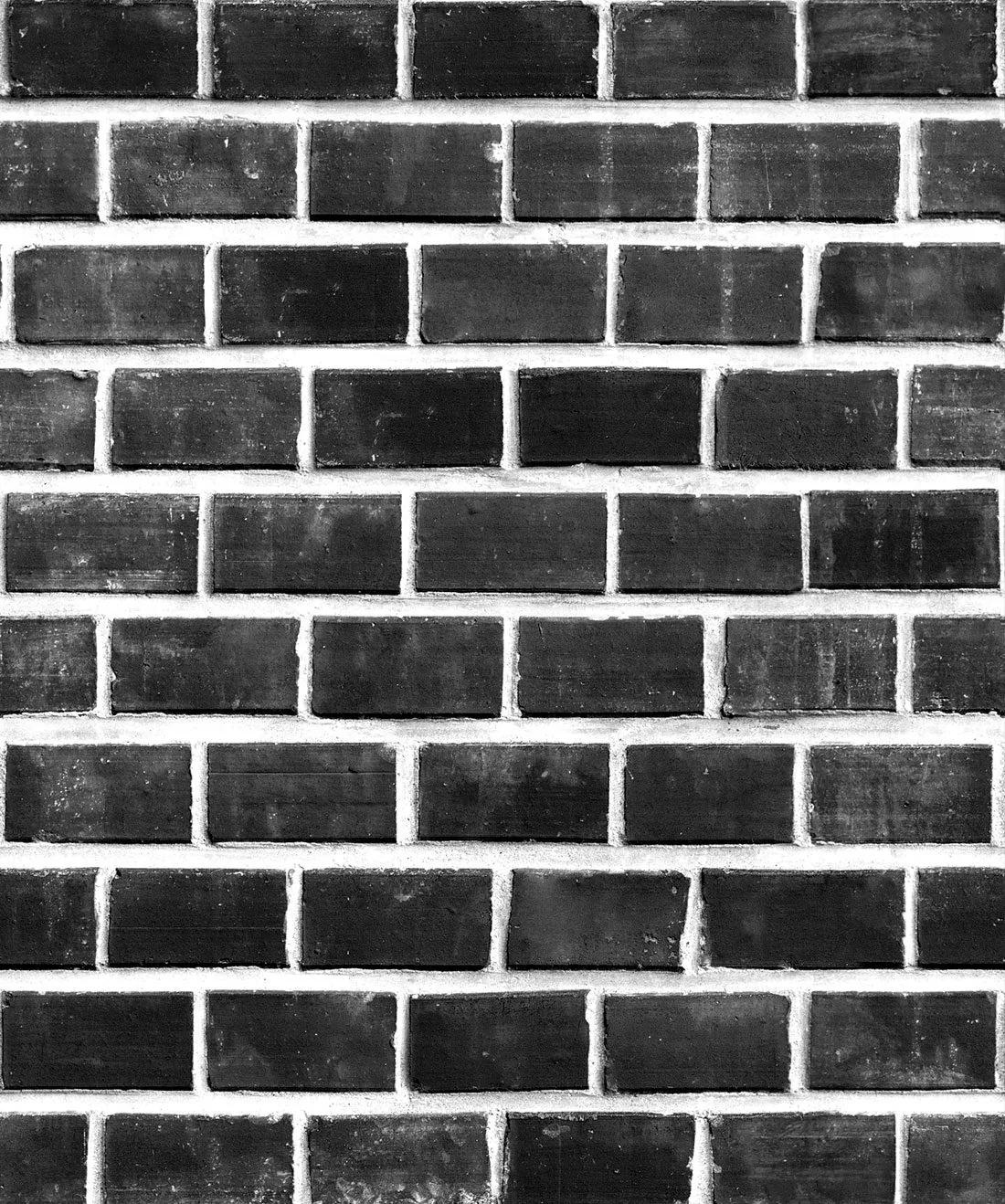 Rows of hand-painted black bricks separated by bright white mortar, the pattern repeating evenly to every edge.