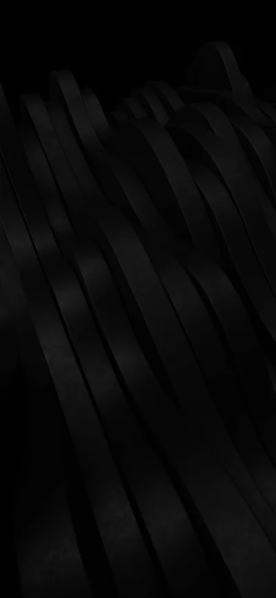 Overlapping strips of black material bend across the frame, lit so faintly that only the folded edges separate from the background.