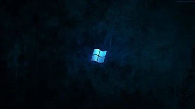 A glowing blue window mark sits at the centre of a scratched dark teal wall, the light falling off at the corners.