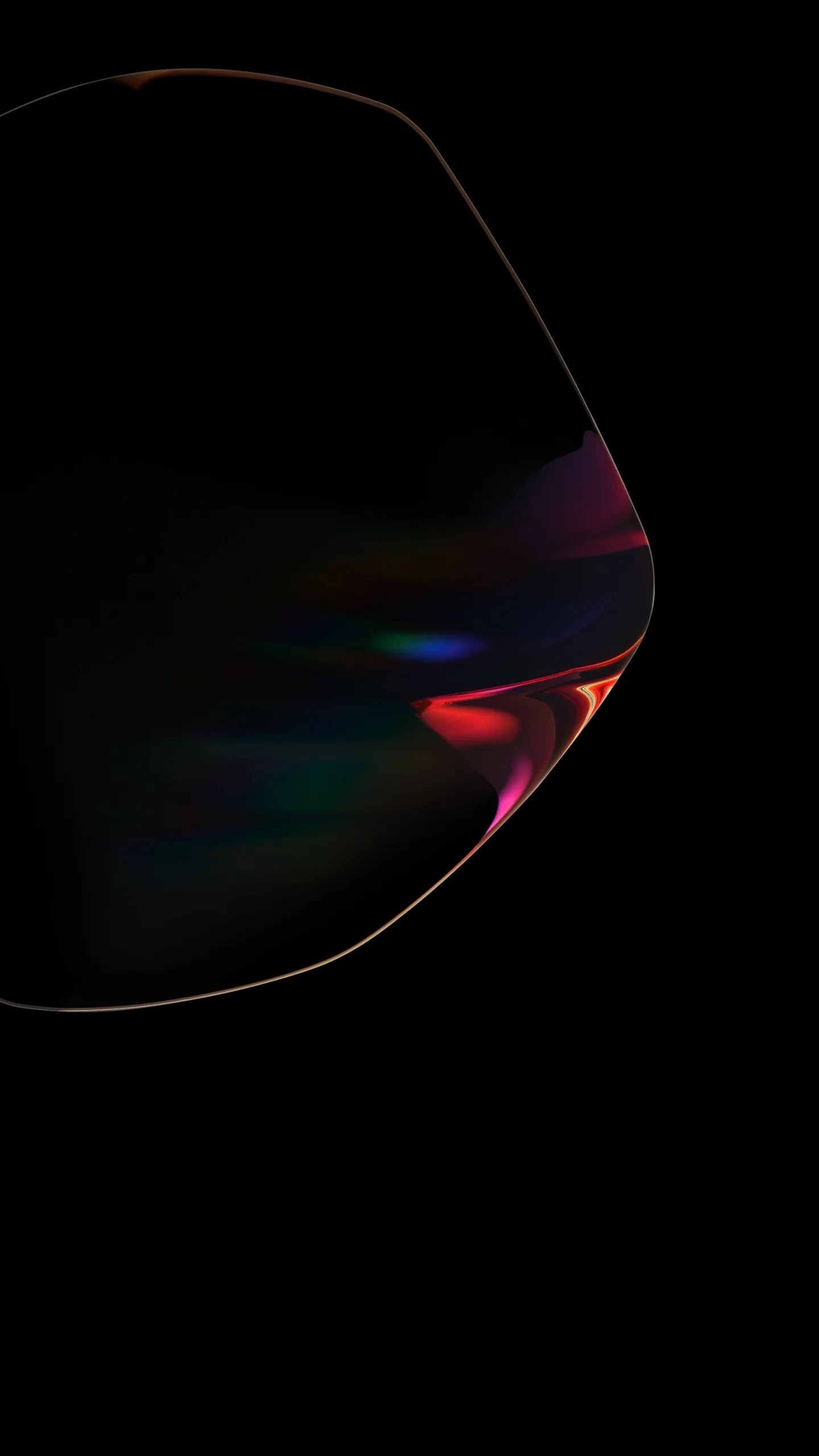 A soap-bubble form floats in the dark with only its rim visible, red and blue refraction gathering along one side against pure black.