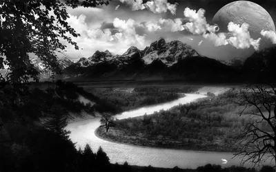 An oversized moon hangs above a jagged range while a river coils through the valley floor, framed by dark branches at both edges.