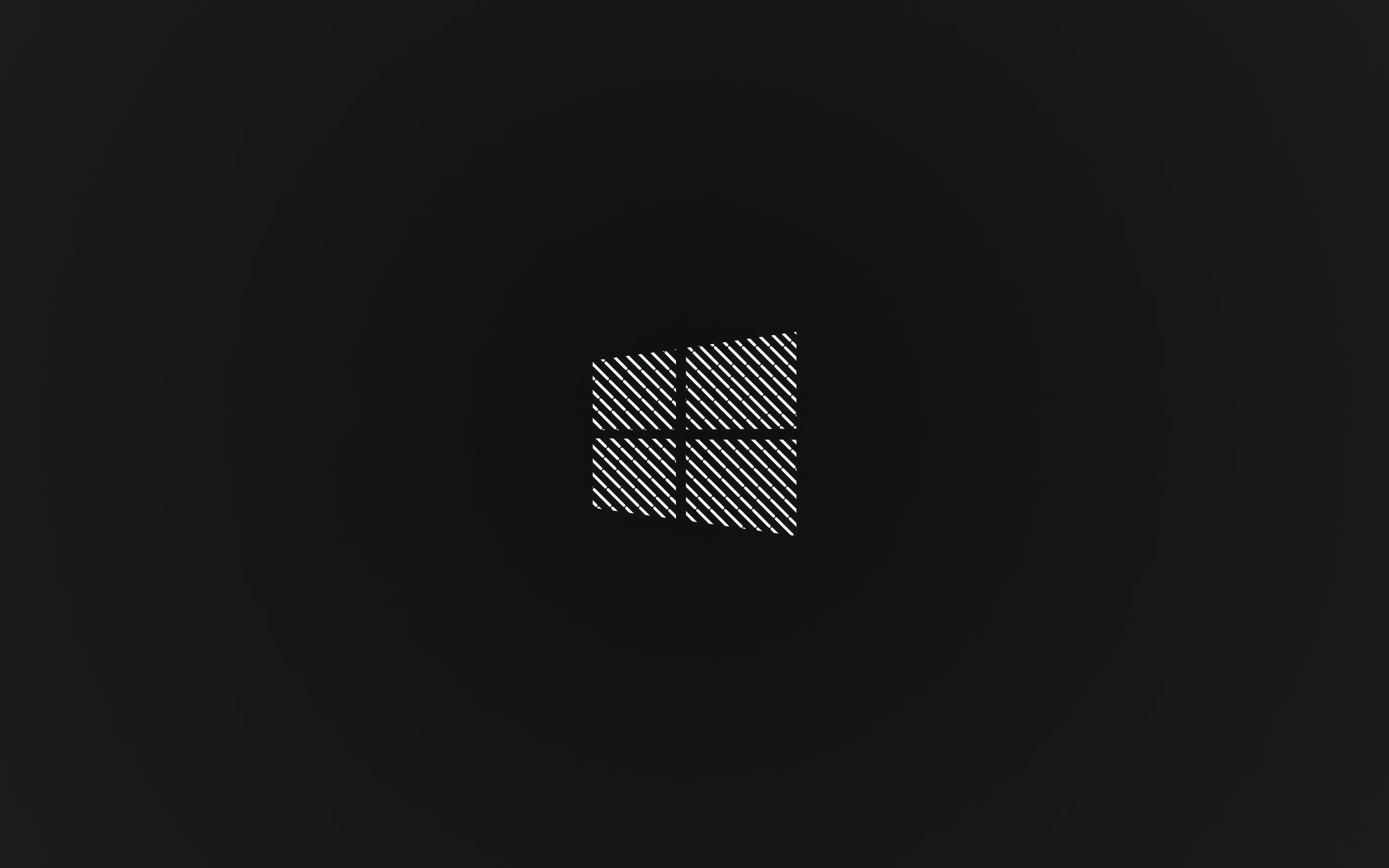 The four-pane mark is filled with a fine hatched texture and set small on a plain charcoal field.