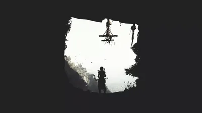 A tiny figure stands in a rough cave mouth, a towering shape crossing the blown-out white sky beyond, everything else pure black.