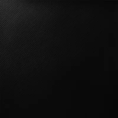 A square field of woven carbon fibre angled to the left, the weave catching light along the top and upper left before the corners go fully black.