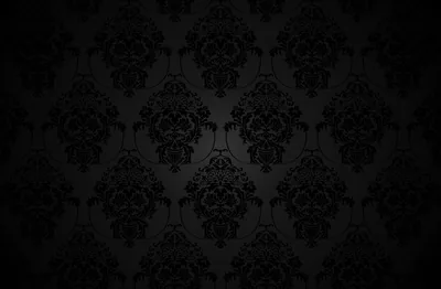 An ornate repeat covers the wall in charcoal on black, dropping to full darkness along the lower edge and corners.