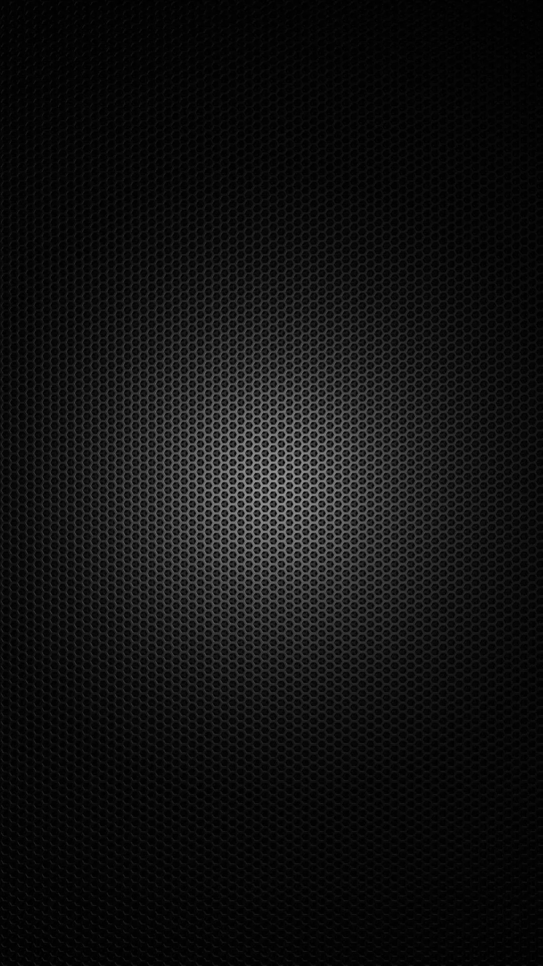 A tight hexagonal weave fills a tall phone frame, lit softly through the middle so the mesh reads as texture before the edges go black.