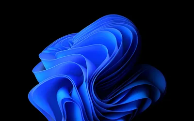 Folded ribbons in bright blue coil into a bloom at the centre of a black frame, edges catching a cooler light.