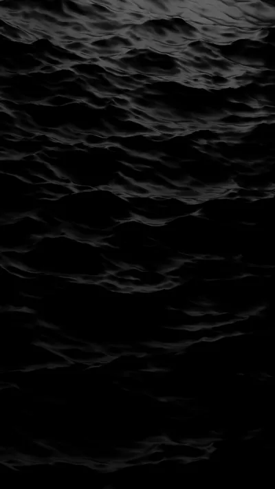 Low black swells fill a tall frame, the water reading almost as texture rather than sea.