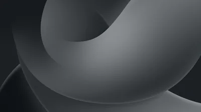 A smooth grey form twists back through itself against a dark ground, its surface shading from silver at the top curve to charcoal underneath.