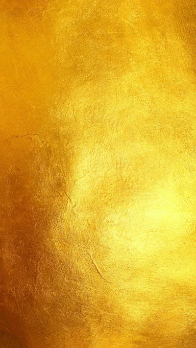 Warm burnished gold with faint mottled brushwork, brightest through the middle of this tall frame and softening toward the bottom edge.