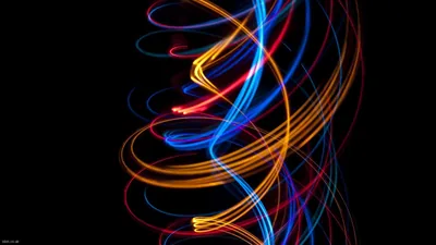 Long-exposure loops of blue, orange and red light coil into a rough helix at the centre, both side edges of the frame left black.