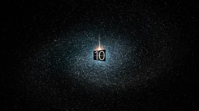 The Windows 10 tile hangs at the centre of an exploding cloud of pale specks, a vertical flare running through it and the edges falling to black.