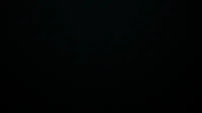 Something tiered sits at the centre of the frame, so far under-exposed that only the edges of each step lift out of the black.