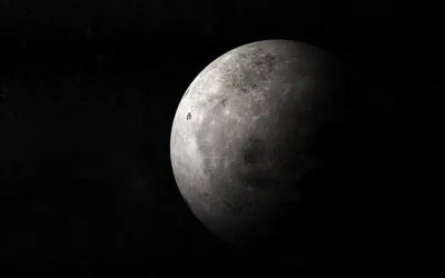 The moon hangs half-lit in deep space, its grey surface fading into black at the terminator.