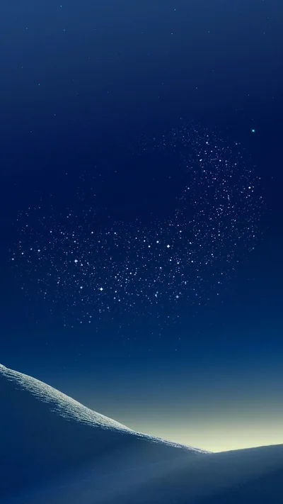 A cluster of small stars floats in a navy sky above a smooth pale ridge, backlit along the bottom edge; the dark upper half keeps the clock readable.