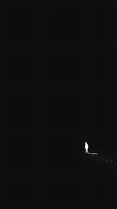 A white silhouette walks a narrow lit strip near the bottom of a tall black frame, with nothing else visible above it.