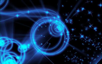 Concentric rings of blue light overlap on the left half among four-point star sparkles, while the right side thins out toward darker sky.