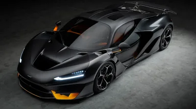 A bare carbon fibre hypercar photographed from above in a grey studio, orange splitter and vents breaking up the dark weave.