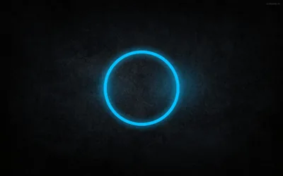 A thin neon blue circle glows at the centre of a scratched dark grey wall, the light falling off quickly into the vignetted corners.