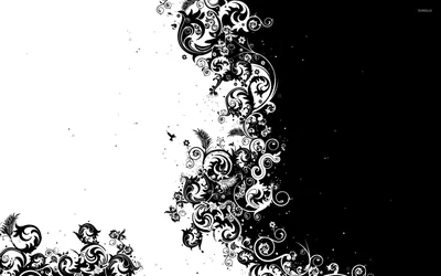 Ornate vine scrollwork splits the frame down the middle, white on the black right side and black on the white left.