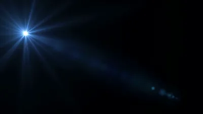 One blue starburst shines from the upper-left corner with a faint dust trail drifting toward centre, the remaining three-quarters of the frame black for OLED.