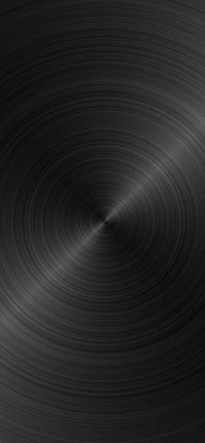 Concentric brush marks spin out from a point low in the frame, the metal reading almost black at the corners and faintly silver near the centre.