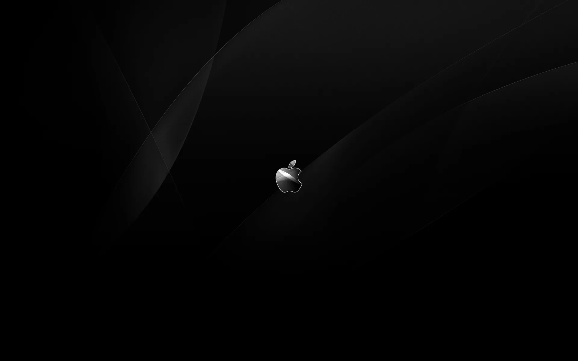 A small chrome Apple logo sits just off centre, faint curved shadows sweeping behind it across an otherwise black desktop frame.