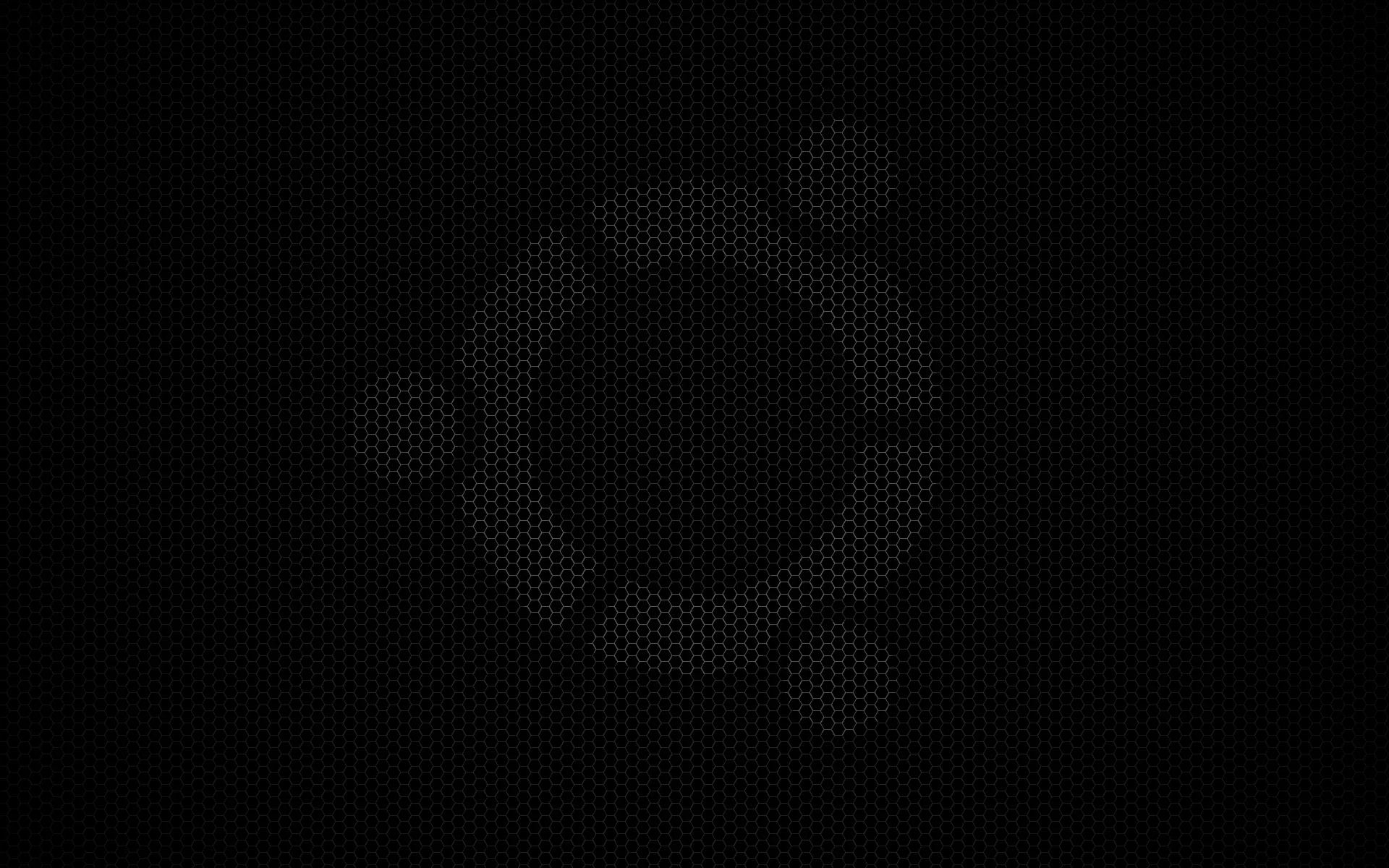The Ubuntu circle mark sits barely a shade brighter than the honeycomb mesh behind it, the rest of the frame held just above true black.