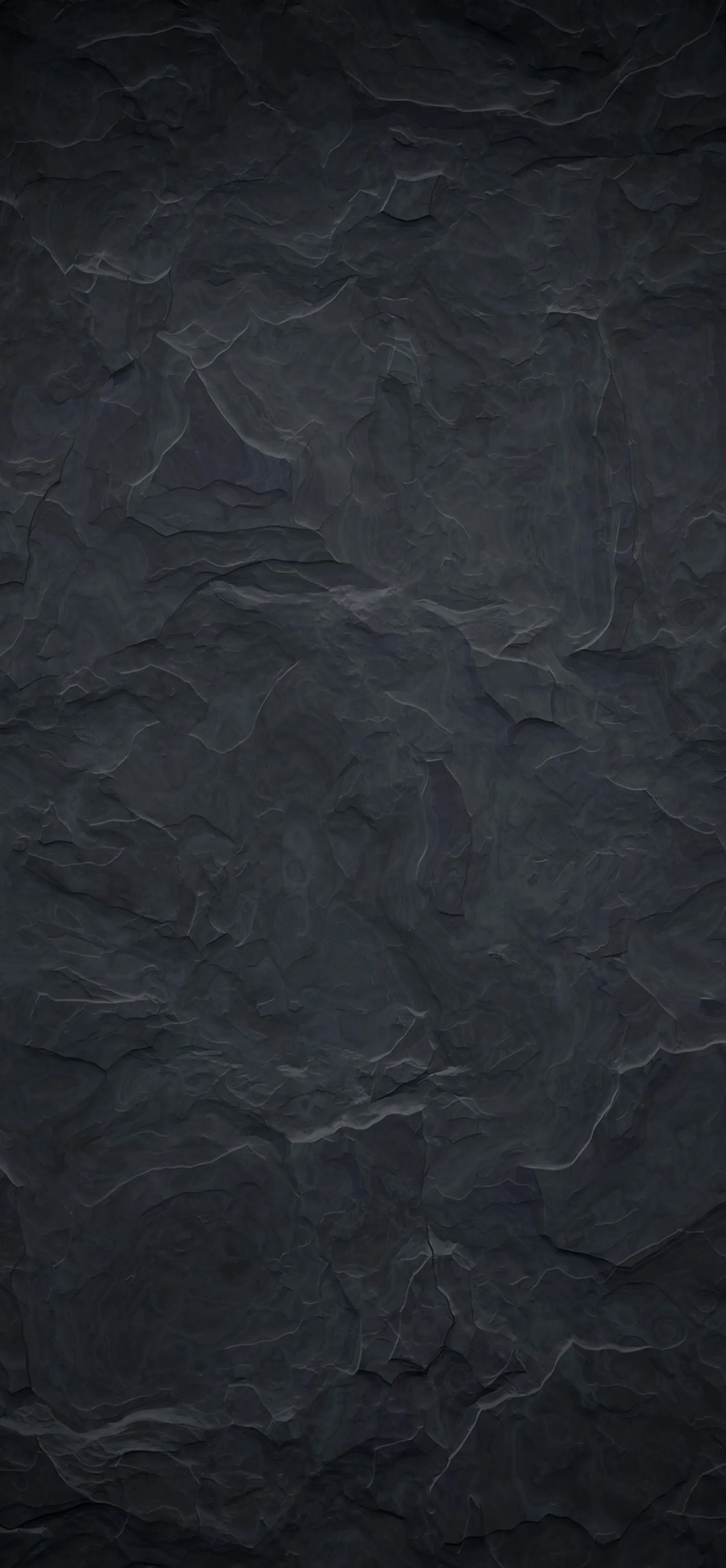 A tall slab of blue-grey slate with hairline veins running through it, the stone flaking in shallow layers down the right side.