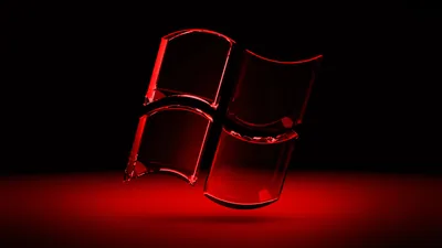 The four panes stand as dark glass blocks on a reflective floor with red light pooling underneath them.