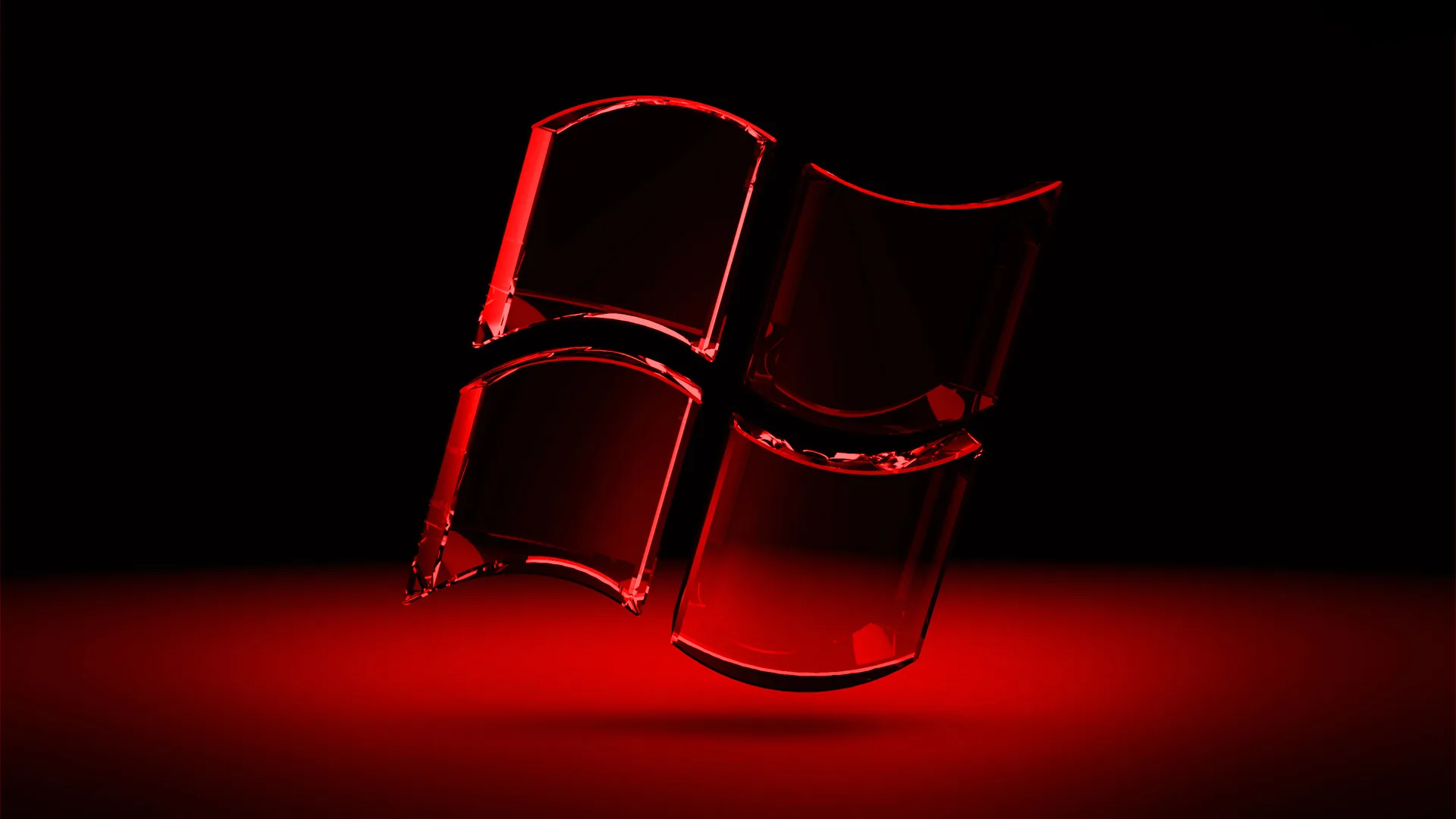 The four panes stand as dark glass blocks on a reflective floor with red light pooling underneath them.