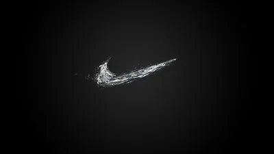 A thin arc of water froze mid-flick into a swoosh shape, floating near the centre of an almost empty charcoal field.
