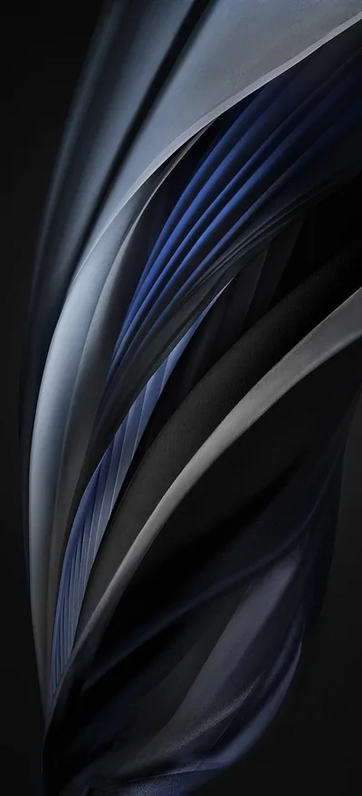 Strands of dark blue silk sweep upward in a curved fan, catching a cool highlight along their ridges before dissolving into the black background.