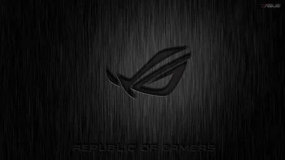 The ROG eye glows faintly through streaks of rain on grey metal, the Republic of Gamers lettering set low along the bottom.