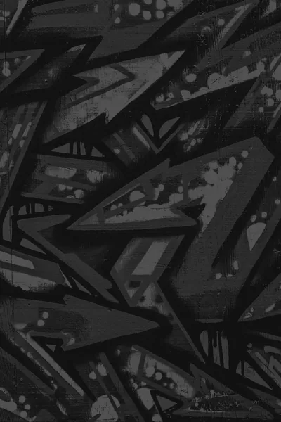 Spray-painted arrows and sharp angular tags overlap down the frame in flat greys, the paint speckled where it was sprayed too close.