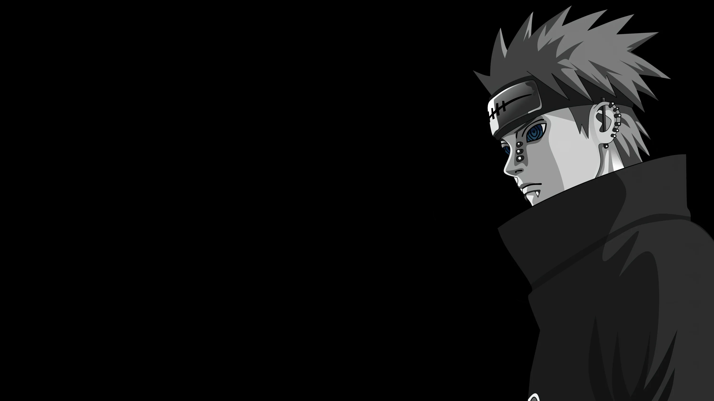 A spiky-haired ninja in a high collar and dark glasses stands at the right, most of the frame left in black.